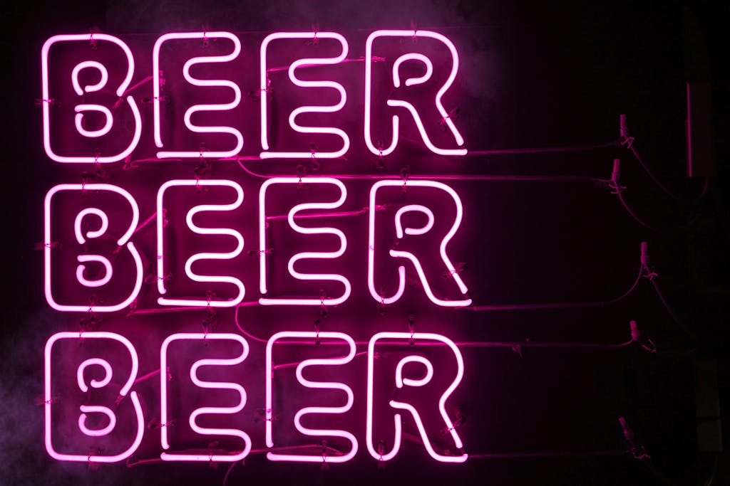 Bright pink neon sign displaying the word 'BEER' in Tokyo, Japan, at night.